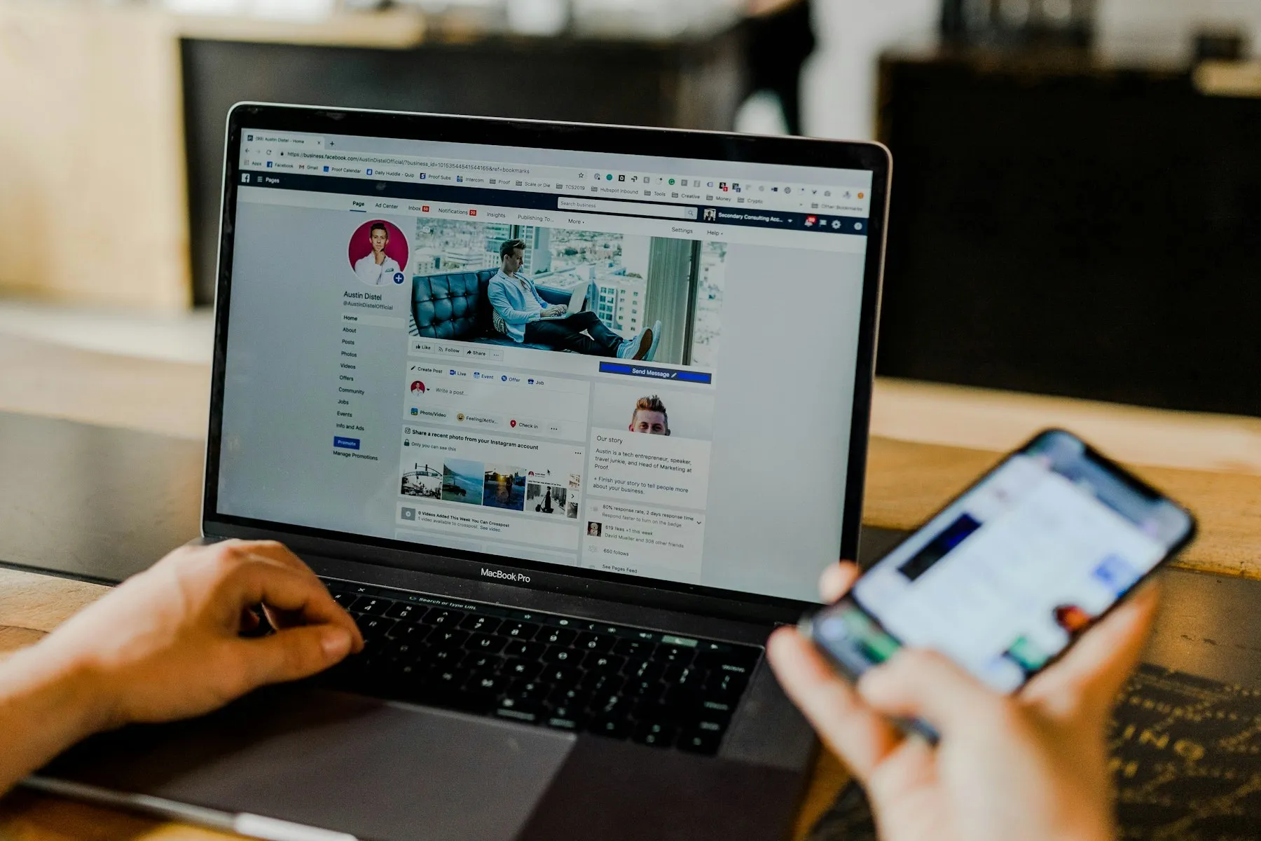 Mengelola halaman bisnis Facebook di laptop sambil memegang HP